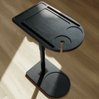 Adjustable black standing desk with rounded edges.