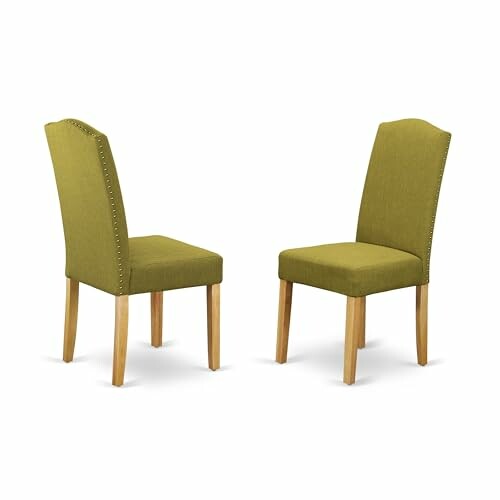 Two green upholstered dining chairs with wooden legs.