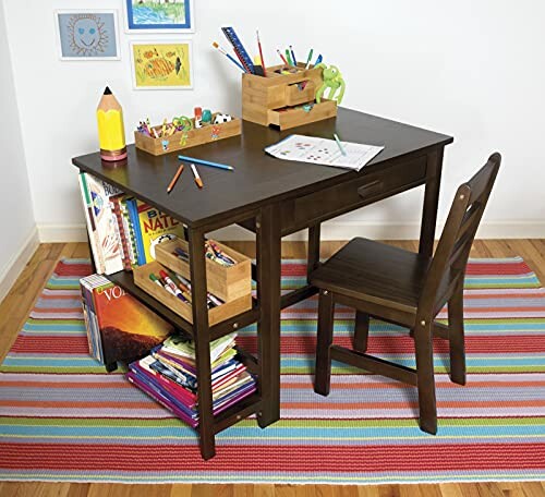 Children's wooden desk with art supplies and chair on a colorful rug.