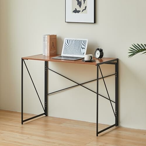 Minimalist desk with laptop, books, and clock.