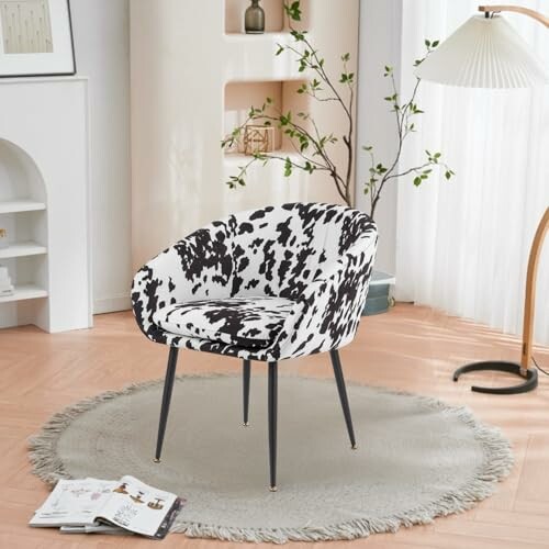 Stylish cow print chair on round rug in cozy room