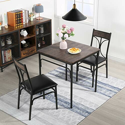 Modern dining room with a table, two chairs, and a vase with flowers.