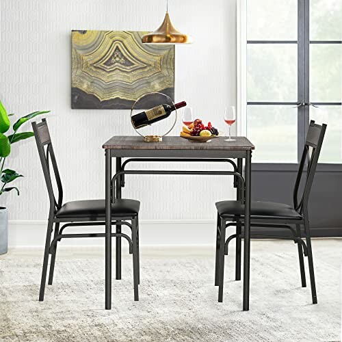 Compact dining table set with chairs, wall art, and pendant light.