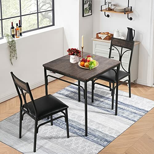 Small dining room set with table, two chairs, and decorations.