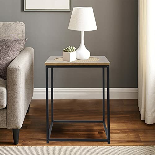 Modern side table with lamp and small plant in living room.