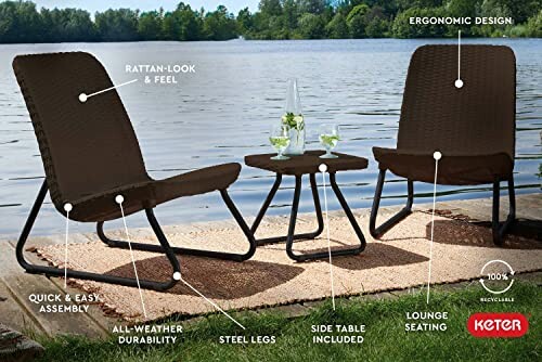 Outdoor patio furniture set with two chairs and a table by a lake.