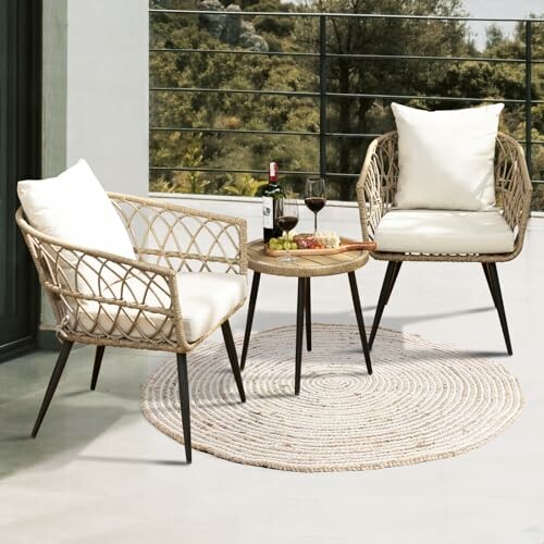 Outdoor patio set with two wicker chairs, table, wine, and snacks.