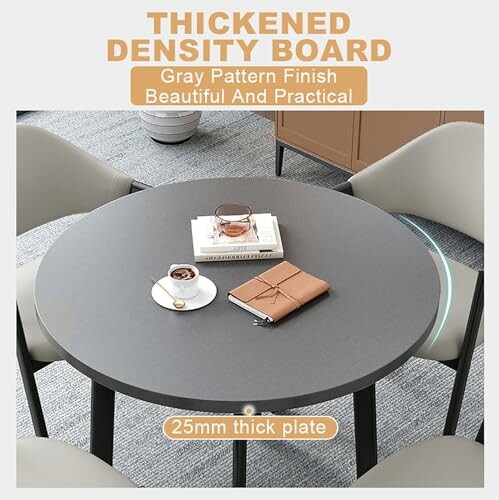 Round gray table with thickened density board, gray pattern finish, featuring a notebook, coffee cup, and glasses.